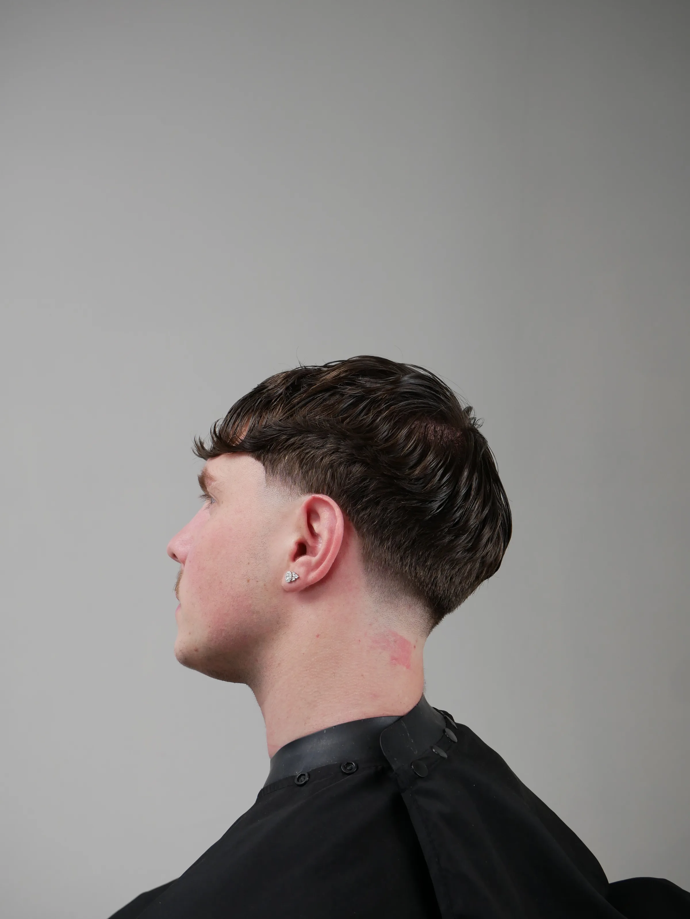 Editorial studio portrait — textured taper, side profile